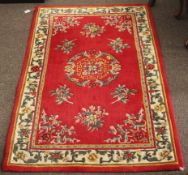 A contemporary oriental style woollen rug.