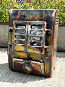 A metal woodburning stove. With hinged front doors and spare metal plates, H60cm x W44cm x D30cm.