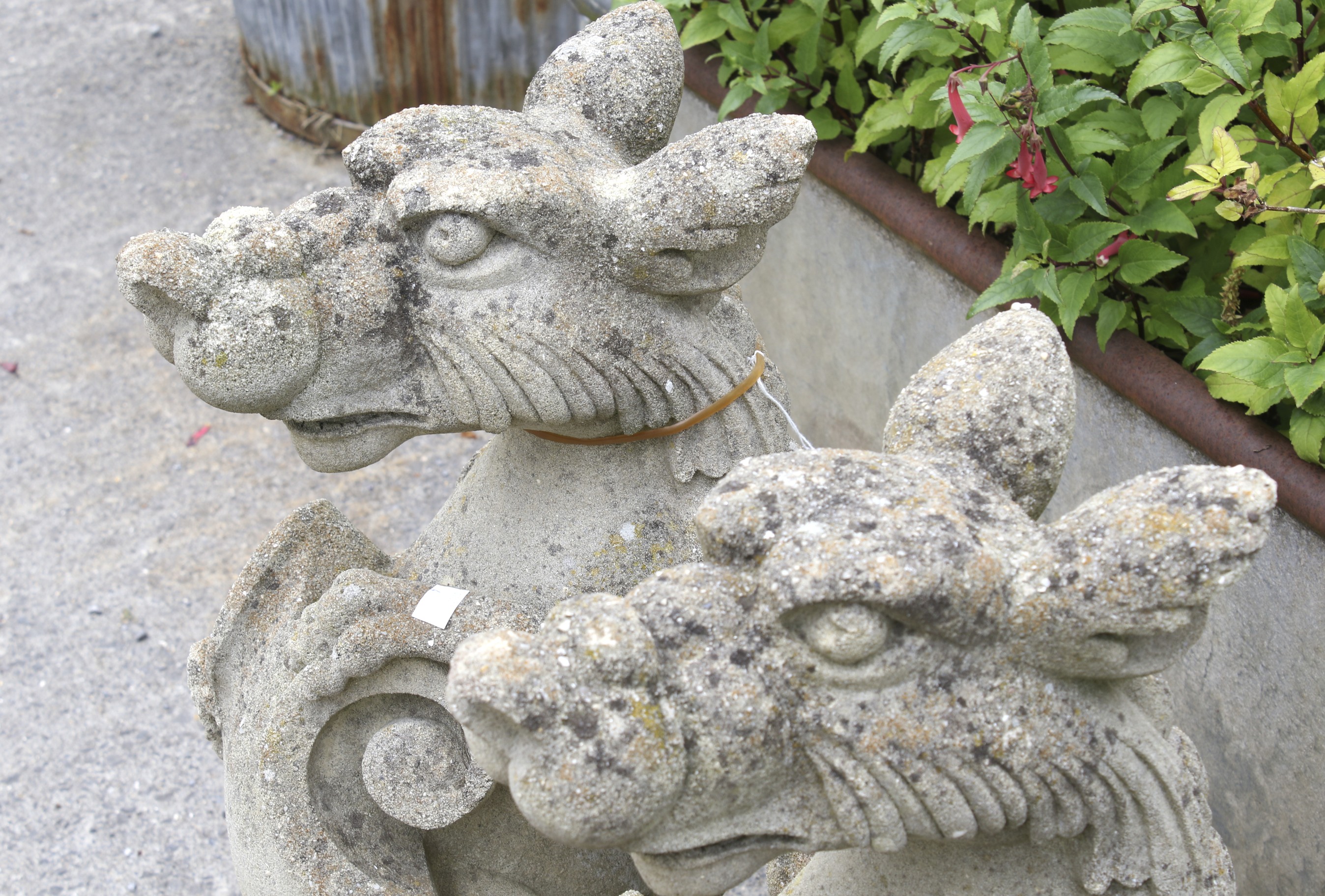 A pair of reconstituted stone statues in the for of Griffins holding shields, approx. - Image 2 of 2