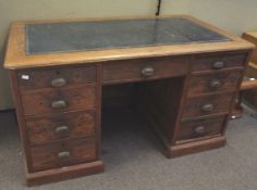 An early 20th century pine twin pedestal desk. With green leather inset top.