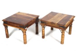 Two contemporary hardwood coffee tables. With metal studded details, raised on turned supports.