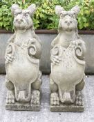 A pair of reconstituted stone statues in the for of Griffins holding shields, approx.