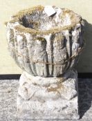 A weathered reconstitiuted stone small round font cast with the twelve disciples,
