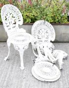 Four vintage cast metal deconstructed garden chairs. Painted white, having pierced decoration.