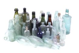 A collection of assorted vintage glass bottles. Including G H Skinner and J Schweppe & Co., etc.
