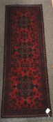 A small Persian style red ground wool rug runner.