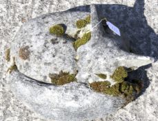 A reconstituted stone fox modelled curled up and sleeping. Approx.