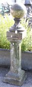 A reconstituted stone square plinth and an associated glazed ball finial.