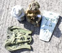 Two wall plaques depicting variations of The Green Man,