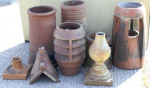 Five various terracotta chimney pots, three ridge tiles and other items.