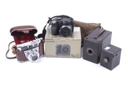 Small assortment of vintage film cameras and a digital camera.
