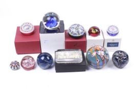 A collection of assorted glass paperweights, some boxed.