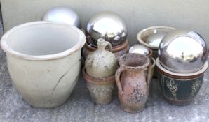 An assortment of glazed garden pots and ornaments.