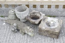A small collection of garden items including a reconstituted stone crocodile.