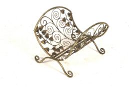 A 20th century cast metal decorative magazine rack.