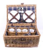 Wicker basket picnic set for four people. Including four china mugs and plates, etc.