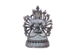 20th century Chinese bronze seated figure of Avalokiteshvara. A seated figure with multiple arms.