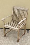 A wooden garden single slat-back seat. With arms and straight square legs.