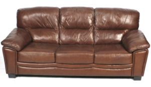 A contemporary brown leather three seat sofa.