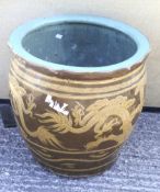 A large glazed garden pot decorated with a Chinese dragon.