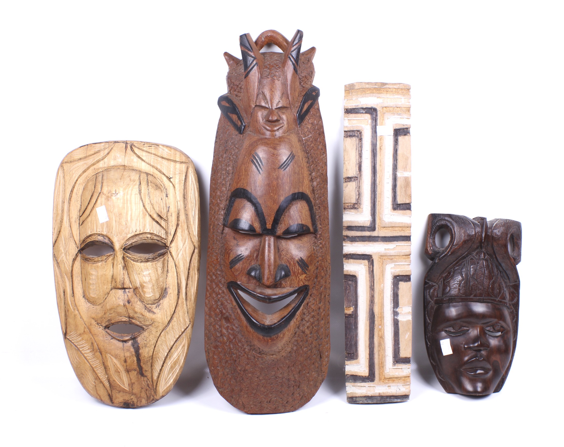 A collection of three assorted tribal masks and a bamboo shield. Max.