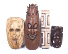 A collection of three assorted tribal masks and a bamboo shield. Max.