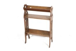 An Arts & Crafts style oak bookcase. Having shaped and pierced sides and three shelves, H85cm x W56.