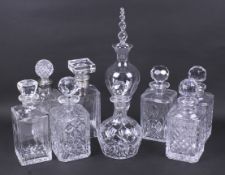 Nine assorted glass drinks decanters.