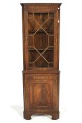A mahogany corner cabinet.