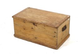 An antique pine blanket box. With wraught iron swing handles at each end.
