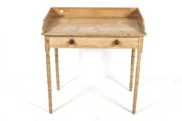 An early 20th century pine washstand. Having a single drawer with bamboo effect supports.