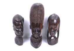 A group of three assorted contemporary African carved hardwood tribal heads.