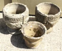 Three reconstituted stone garden pots.