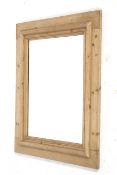 A rustic pine framed wall mirror.