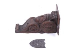 A carved wall bracket and lead shield.