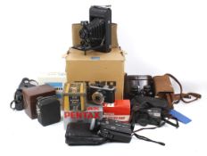 A collection of assorted film cameras and binoculars.