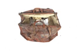 A large vintage brown leather Gladstone bag.