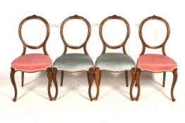 Set of four balloon carved back mahogany framed chairs.