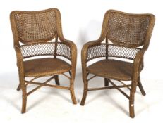 A pair of wicker armchairs.
