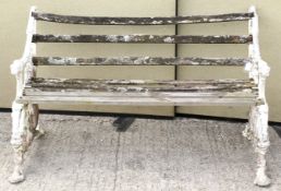 A vintage garden bench. Having cast metal bench ends painted white and joined by wooden slats.