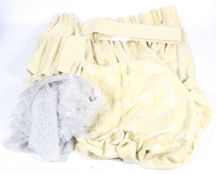 A pair of lined and pleated yellow embroidered fabric curtains.