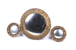 Three early 20th century convex circular wall mirrors.