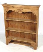 A pine freestanding bookcase, possibly repurposed from a kitchen dresser.