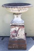 A late 19th/early 20th century cast iron garden urn and pedestal in neo-classical style.
