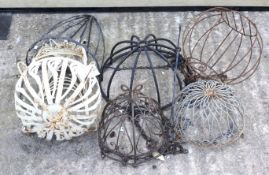 Six metal framed garden hanging baskets in various designs including a lightcream painted