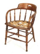An Edwardian oak bentwood frame open armchair.