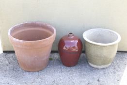 Three garden pots. Comprising a terracotta pot, a glazed pot and a red glazed urn. Max. H39.