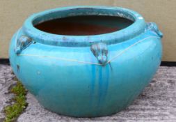 A large contemporary turquoise glazed circular garden planter.