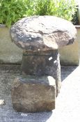 A red sandstone 'mushroom-shaped' staddle stone.