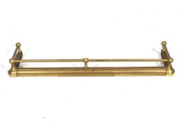 A early 20th century adjustable sliding brass fire fender. With brass rail.